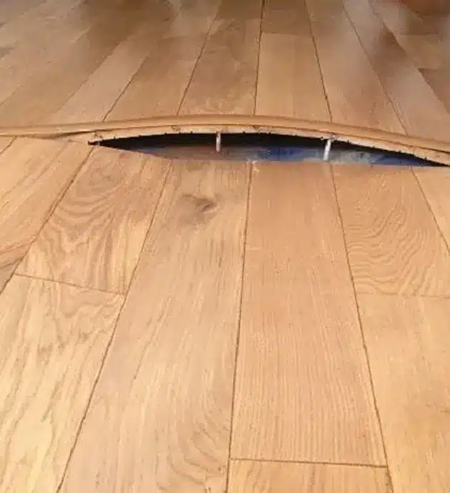 wood floor buckle water leak